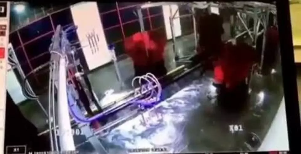 Manager Goes for a Wild Ride as He Gets Stuck in a Giant Car-Wash Brush