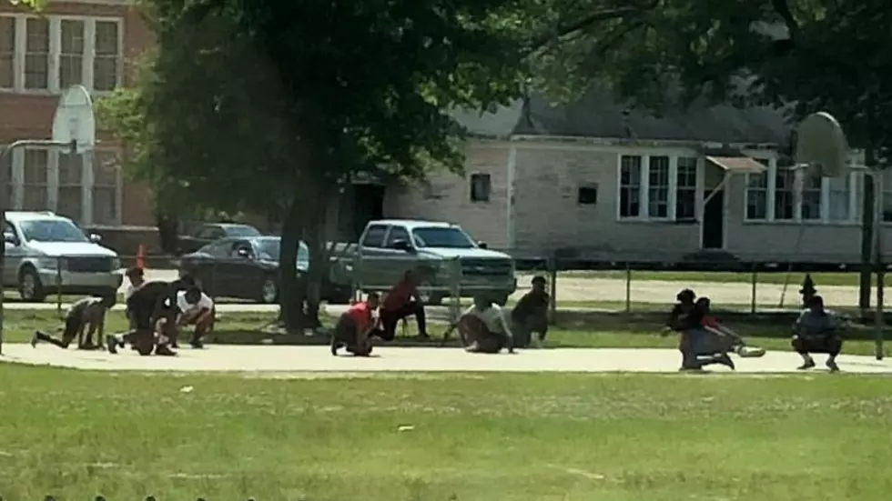 Group of Teens Playing Basketball Kneel to Pay Respects for the Dead