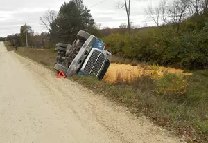 Grain Truck Loses Load in a Ditch; Driver is OK