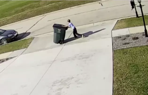 Kid Gets Taken Out By Garbage Can On Windy Day