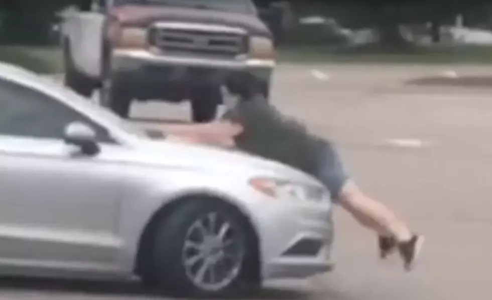 Shocking Video of Michigan Woman Jumping On Car To Stop Theft