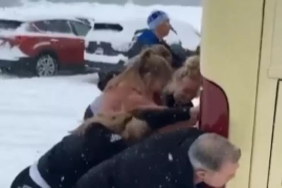 WATCH: Michigan Women’s College Team Pushes Bus Out of Snow, Wins Game