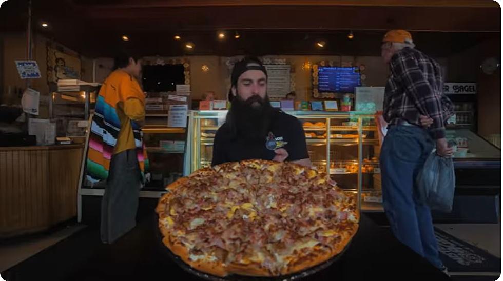 Competitive Eater Crushes Portland Mister Bagel’s Breakfast Pizza Challenge