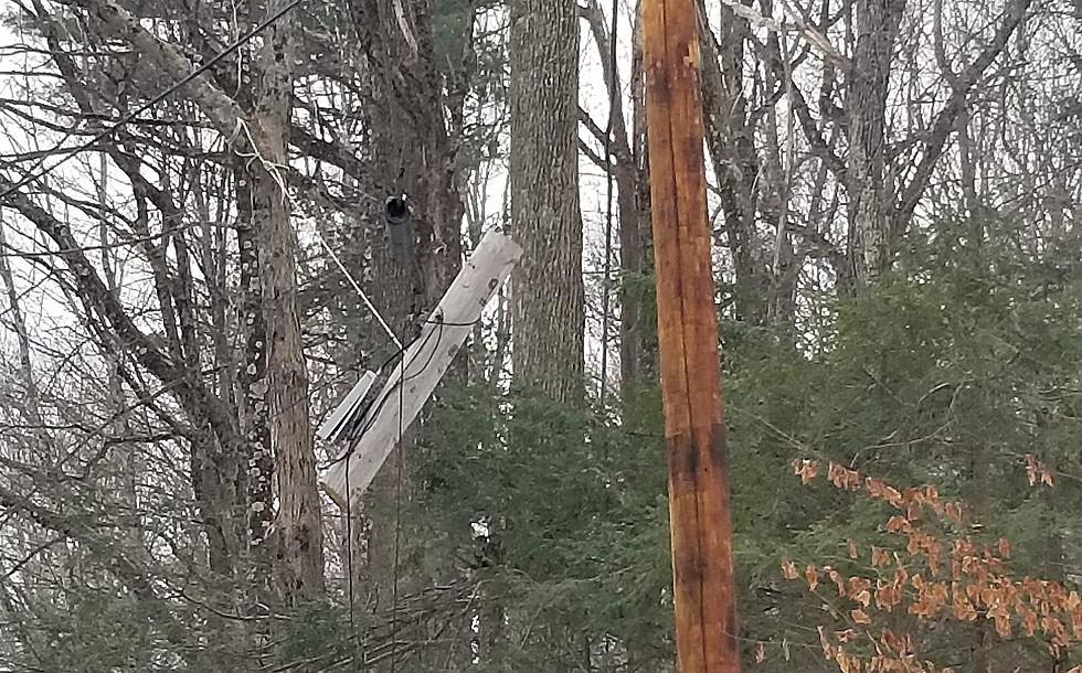 A Piece Pole with Wires Hangs Near a New Utility Pole No One Knows Why