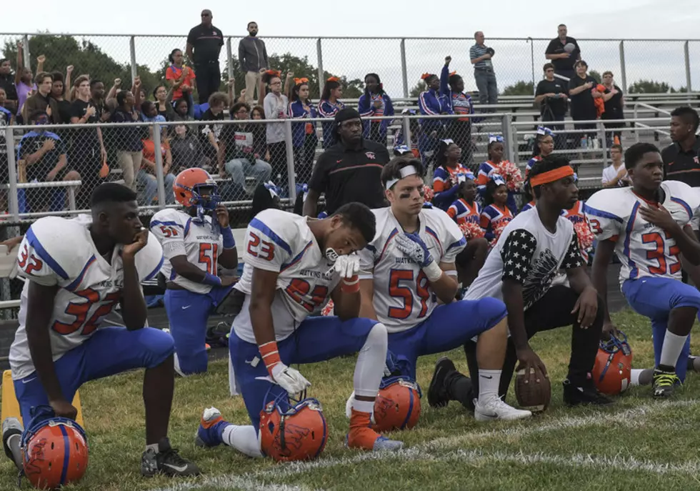 Iowa High School Football Team Near QCA Kneels During The Anthem