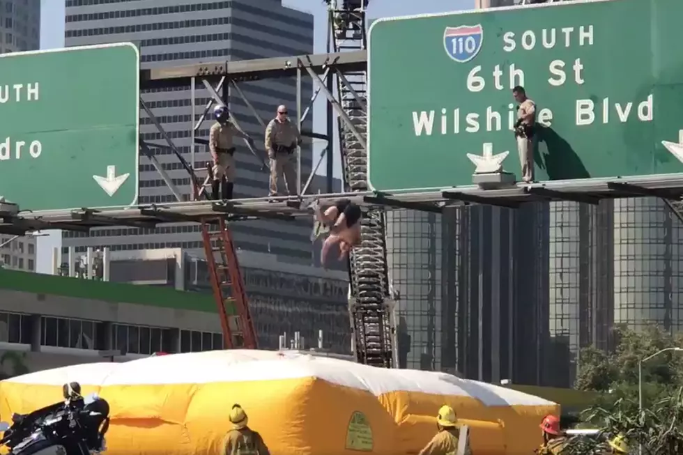 Traffic Stopped As Man Back Flips Off Los Angeles Traffic Sign