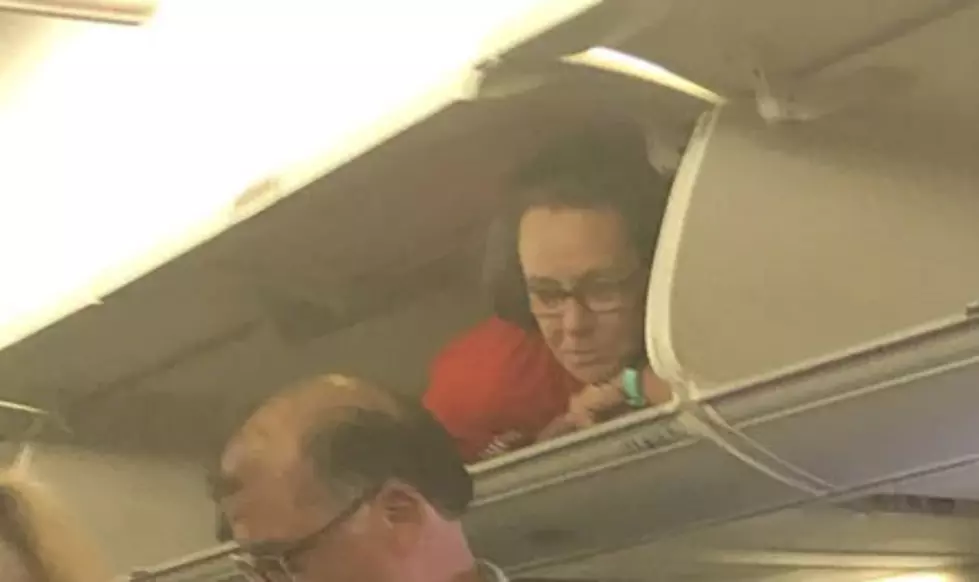 Flight Attendant In Overhead Compartment Shocks Passengers