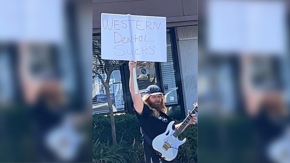 Man Protests Dental Office By Setting Up Outside And Wailing On Guitar