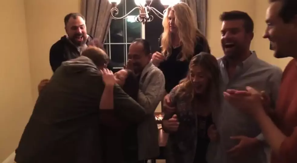 Couple Surprises Friends With Pregnancy Announcement During Group Photos [VIDEO]
