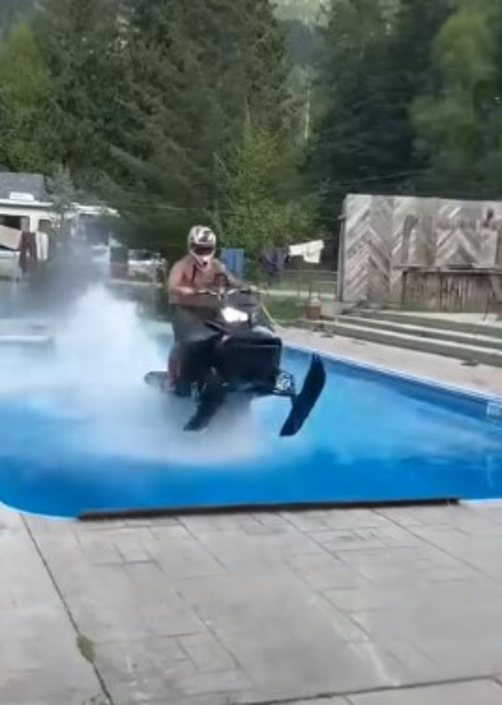 [VIDEO] Guy Rides Snowmobile Over Pool, Crashes