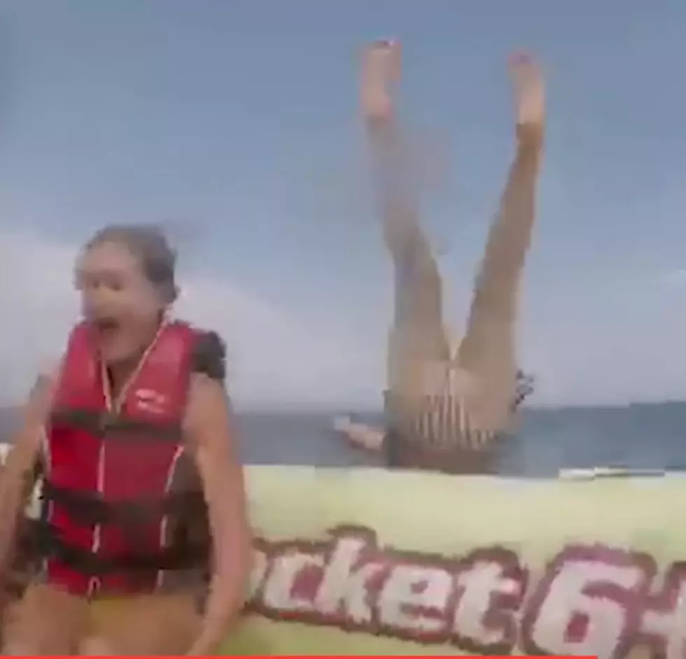 A Woman Flies Off the Back of an Inflatable Raft