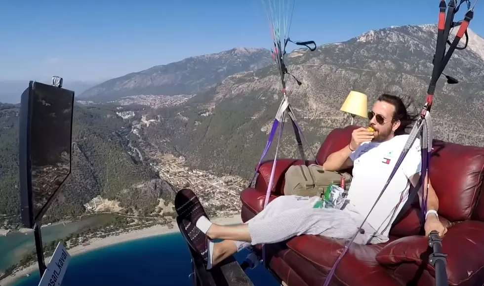Paraglider Watches TV on a Couch While Flying High Above the Ground (Video)