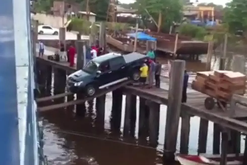 Truck on Razor Thin Plank Defies Science to Board Boat [VIDEO]