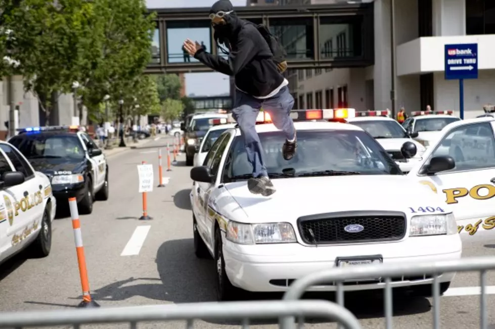 Man Tries to Impress His Friends by Standing on a Police Car, Gets Arrested