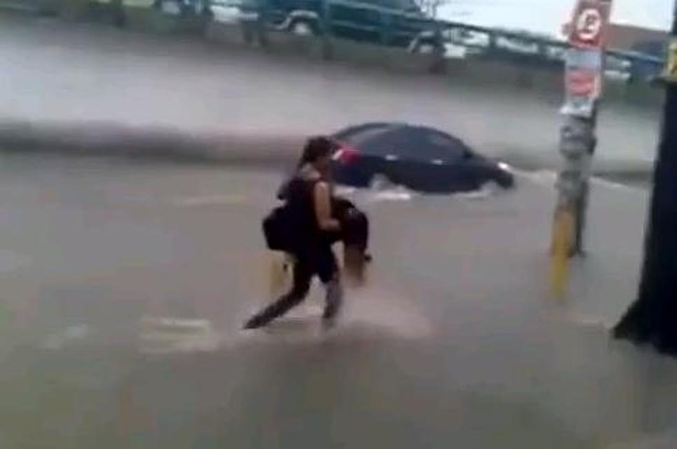 Guy Carries Women Through Flood, Falls In Hole [VIDEO]