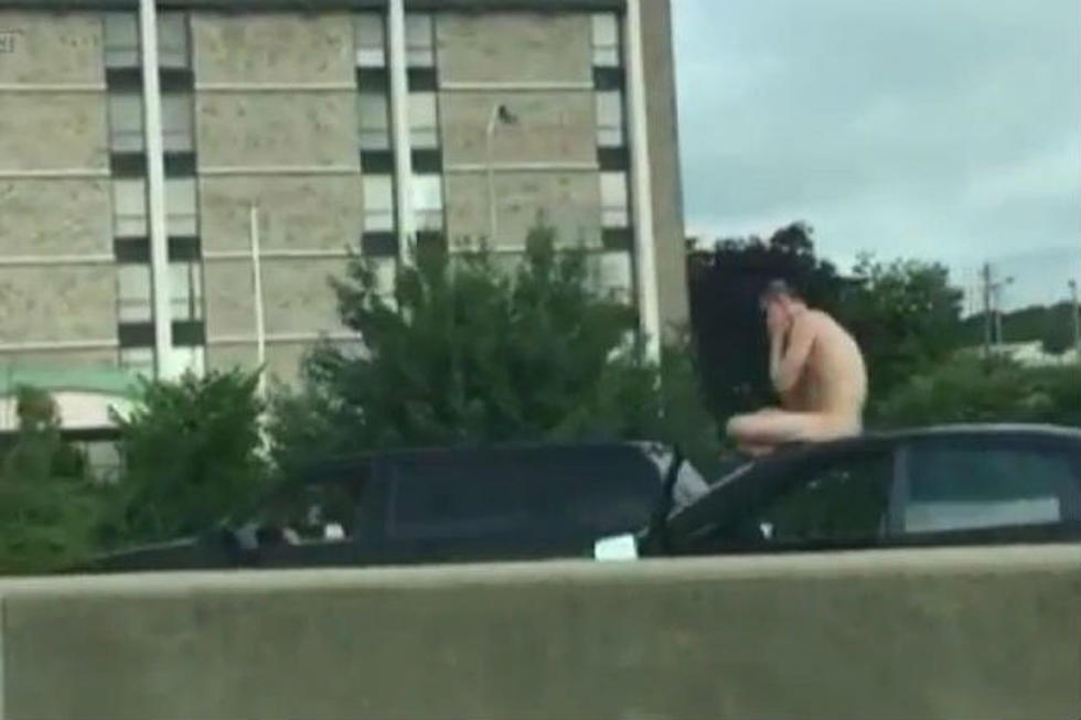 Naked Man Riding on Top of a Car Causes Traffic Jam [VIDEO]
