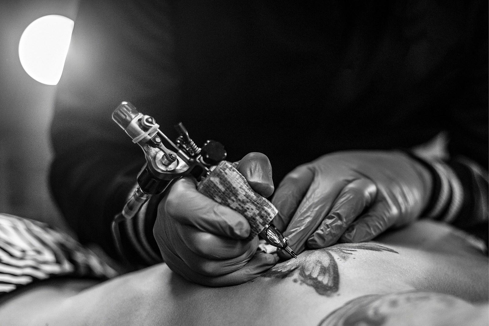 Professional tattoo artist stuffs a tattoo on the man's hand. Tattoo artist  at work. Tattoo creation process. Art and creativity 19948181 Stock Photo  at Vecteezy