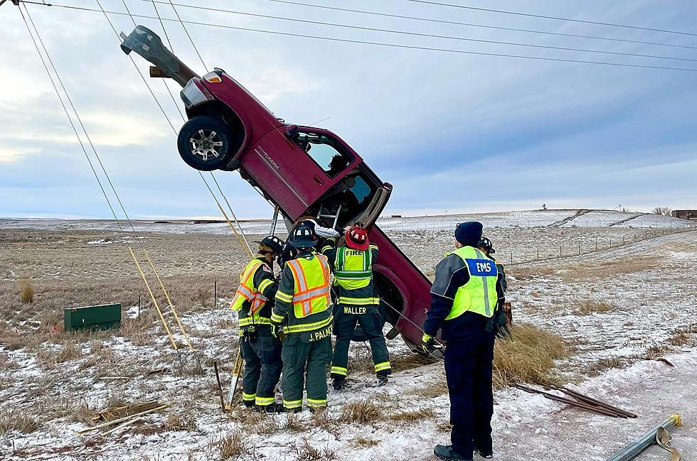 Vehicle Comes To Rest On Power Pole In Wyoming