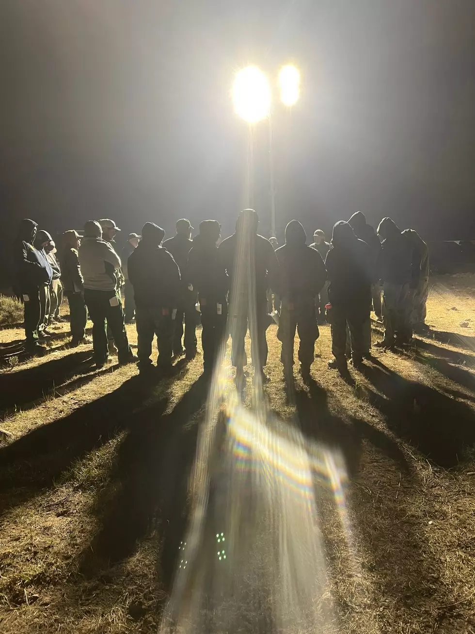 Firefighters on the Dollar Lake fire receive early morning briefing on division-specific information.