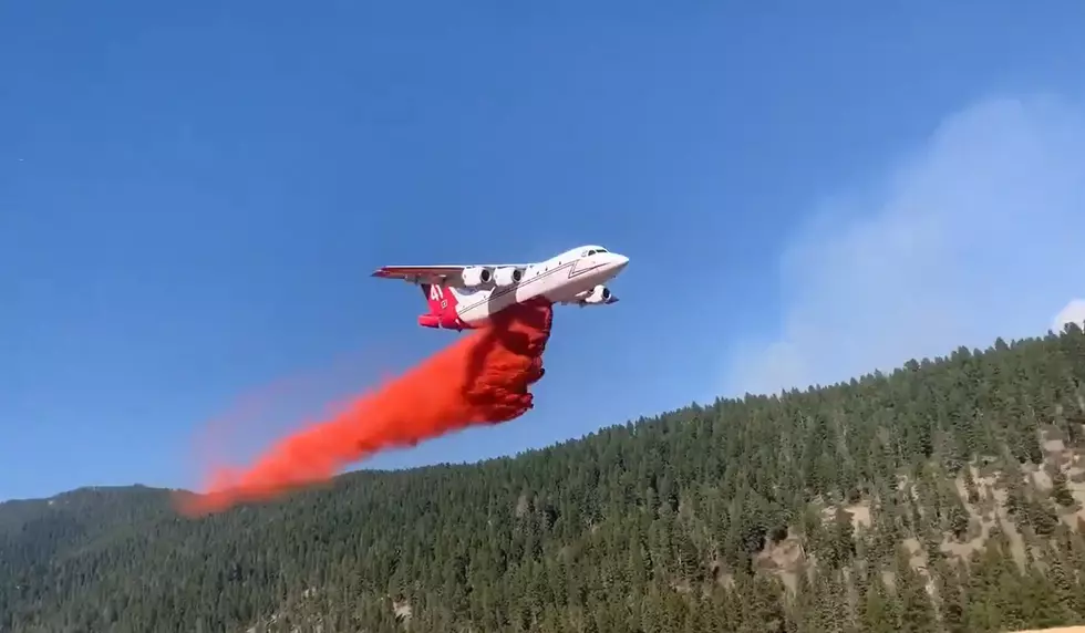 Watch a Plane Drop Chemicals to Save a Log Cabin from a Wildfire