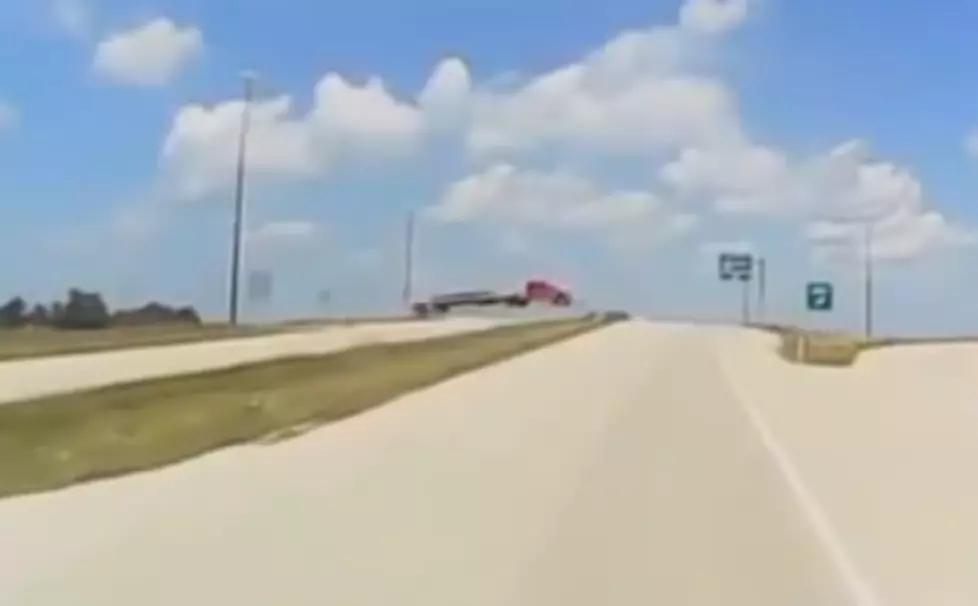 Semi Truck Flies Over Road, Bursts Into Flames [VIDEO]
