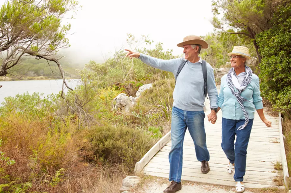 Senior couple walking together by a lake