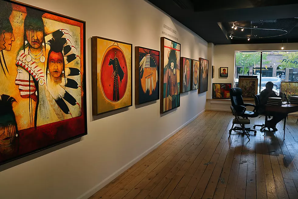 Kevin Red Star sits at the Dana Gallery surrounded by his work on a recent weekend in downtown Missoula. (Martin Kidston/Missoula Current)