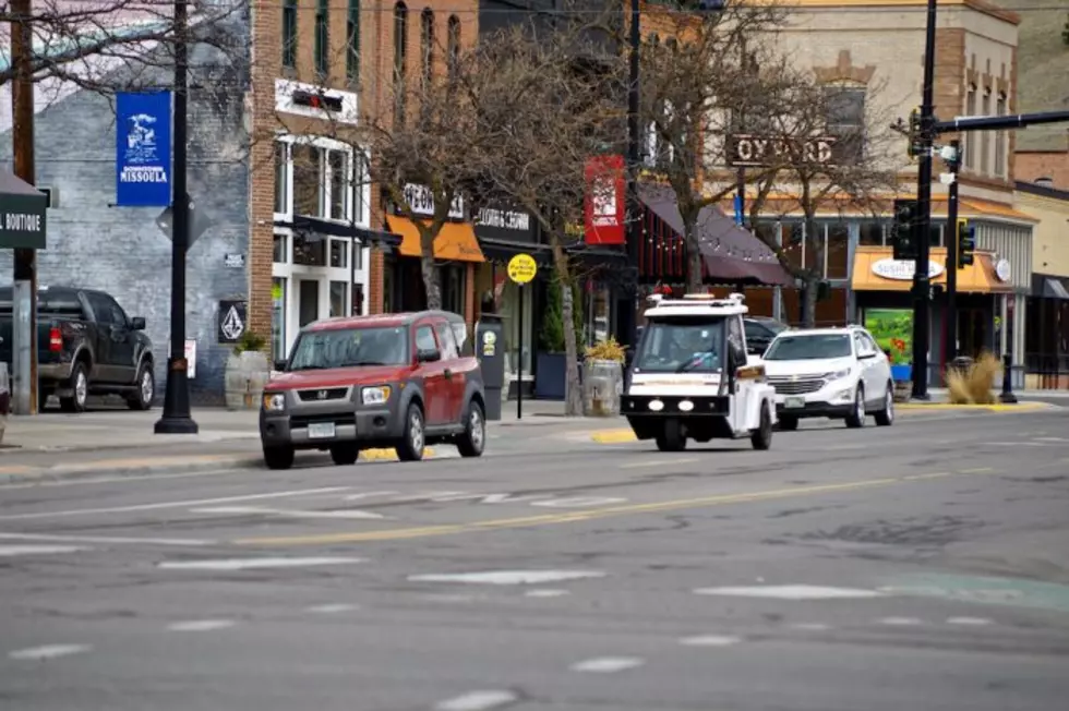 A parking attendant patrols the street in downtown Missoula. (Martin Kidston/Missoula Current file)