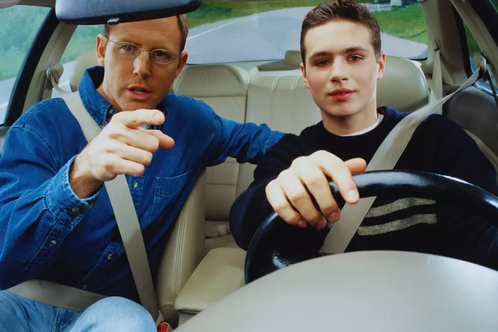 A father teaching his son how to drive