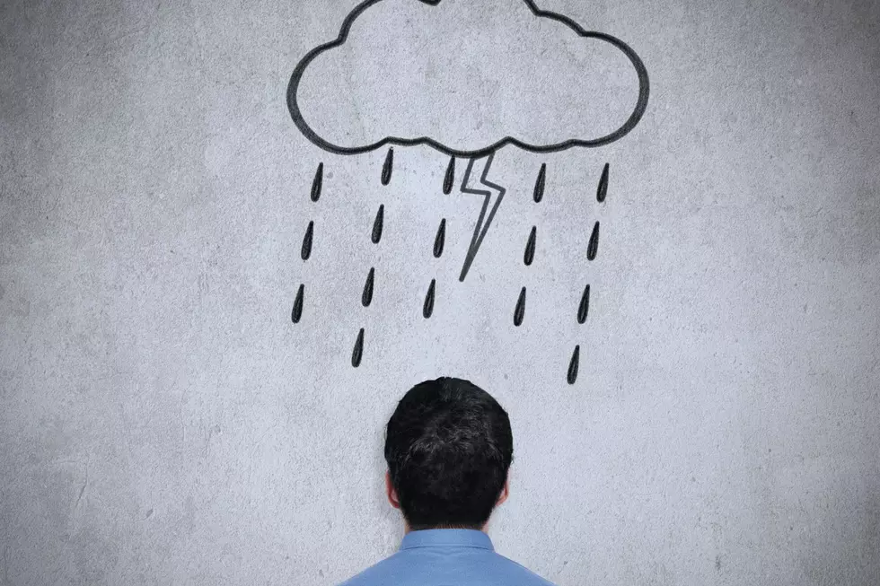 The back of a mans head is shown under a graphic of a cloud with rain and lightning bolt