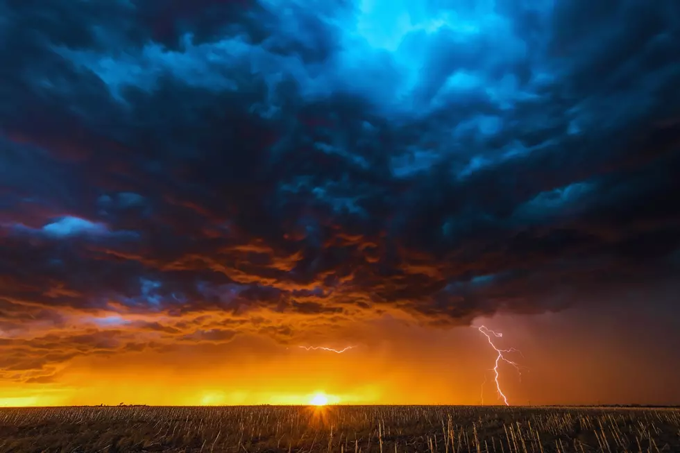 a lightining bolt strikes the ground at dusk