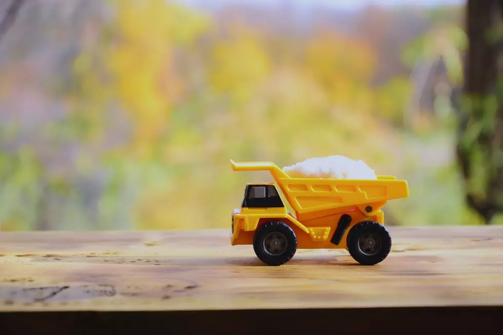 A toy dump truck with a tiny load of salt