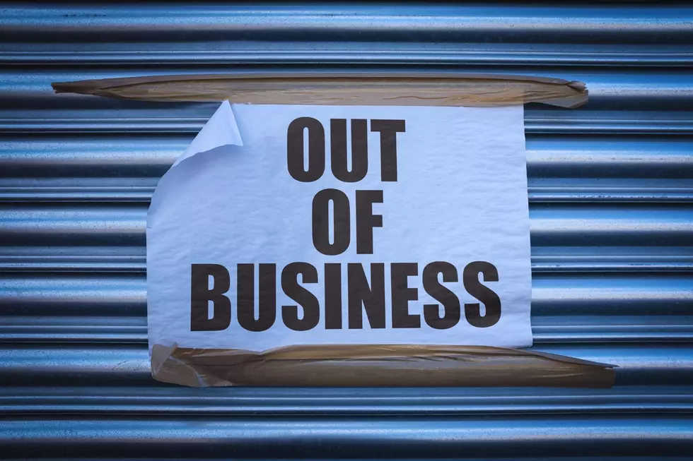 A paper with the words "out of business" on it is taped to a wall