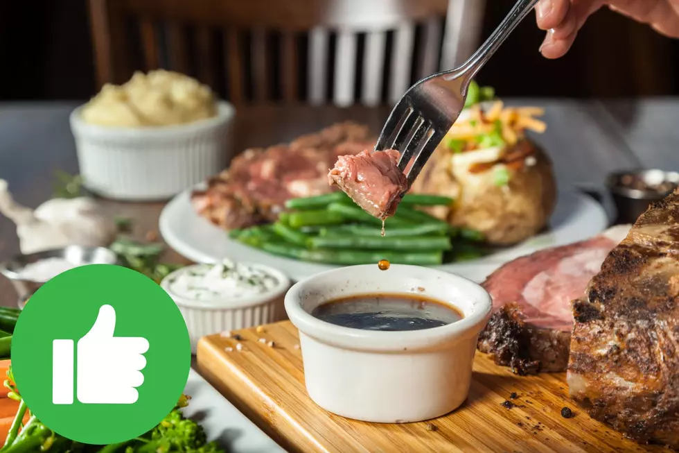 Dipping a piece of prime rib in au jus with a green thumbs up graphic