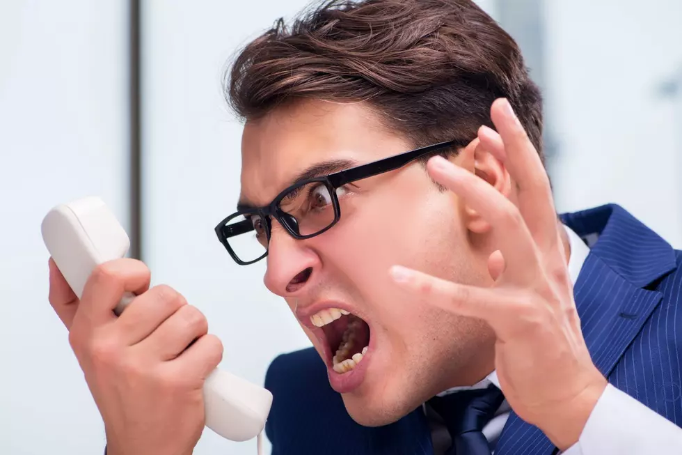 A man yells into his phone