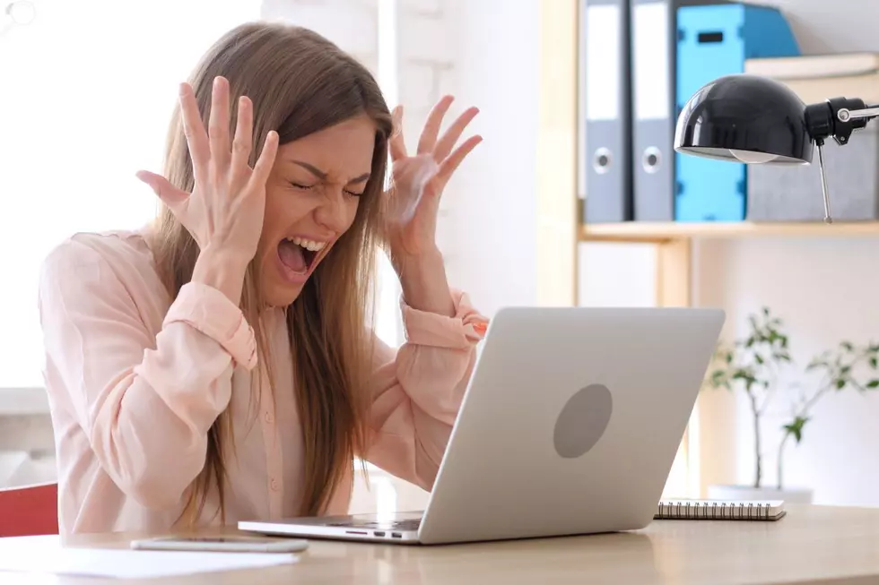 A woman yells at her laptop