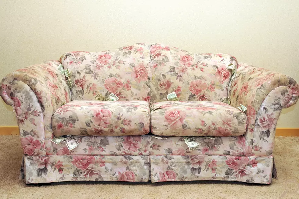 A couch with money sticking out of it