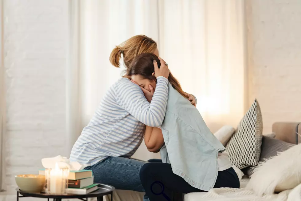 Two women consoling each other by hugging