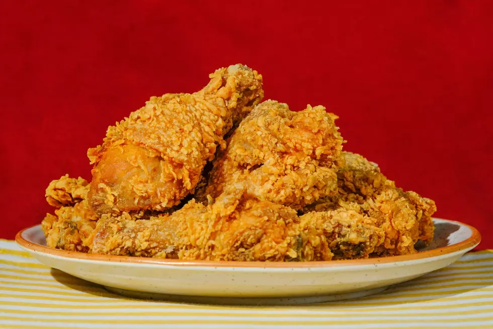 A plate of fried chicken against a red backdrop