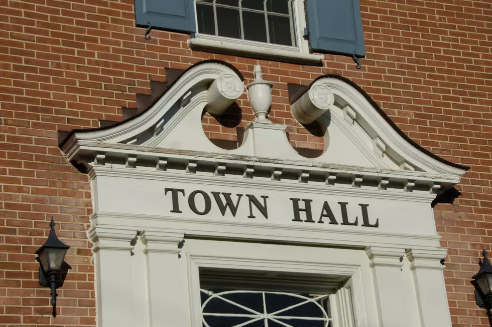 The front of a building that stats "town hall"