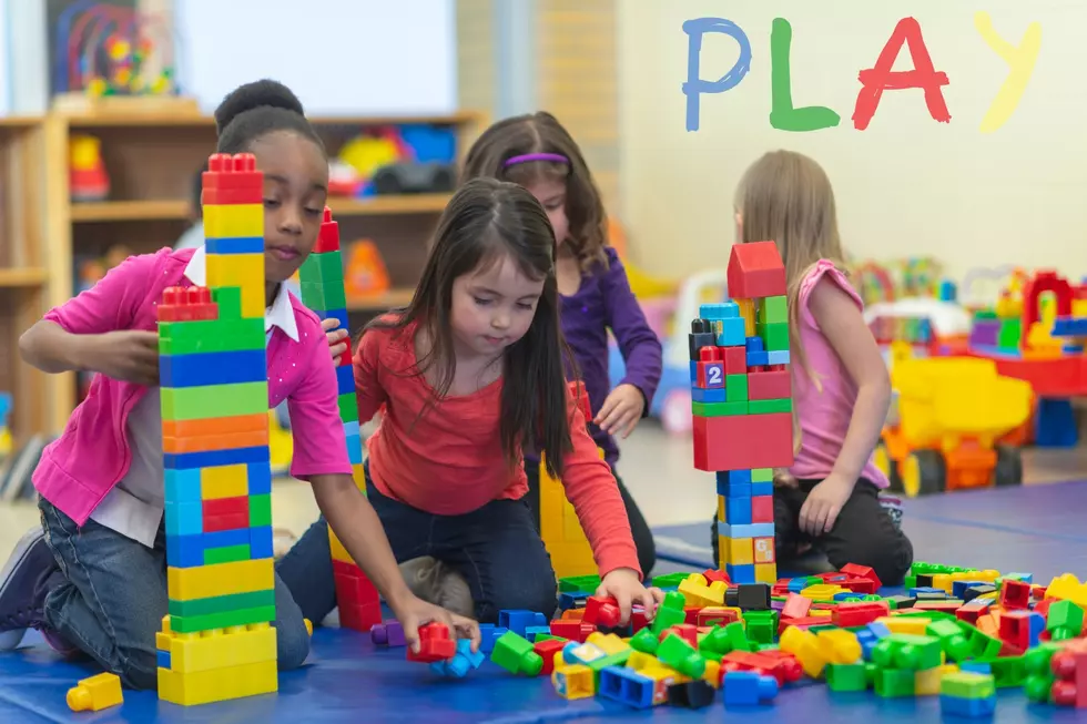A group of kids playing with duplo blocks