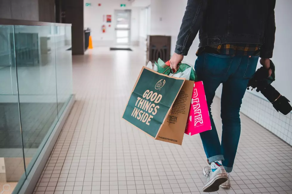 man in mall with bags and camera