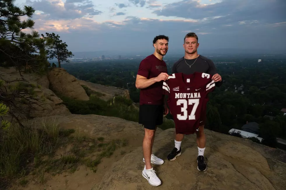 Gradney (left) with the ceremonial #37 passing to Oven (right). Credit: University of Montana Athletics