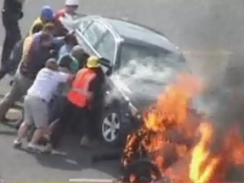 Heroic Crowd Lifts Burning Car Off Motorcyclist in Incredible Footage [VIDEO]