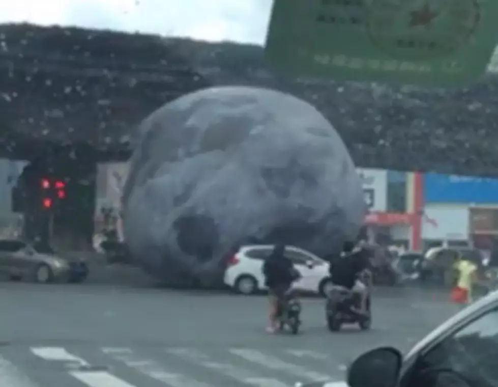 Giant Inflatable Moon Rolls into Traffic!