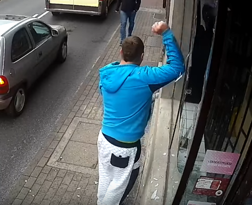 Bad Guy Smashes Window and Immediately Gets Hit By Car!