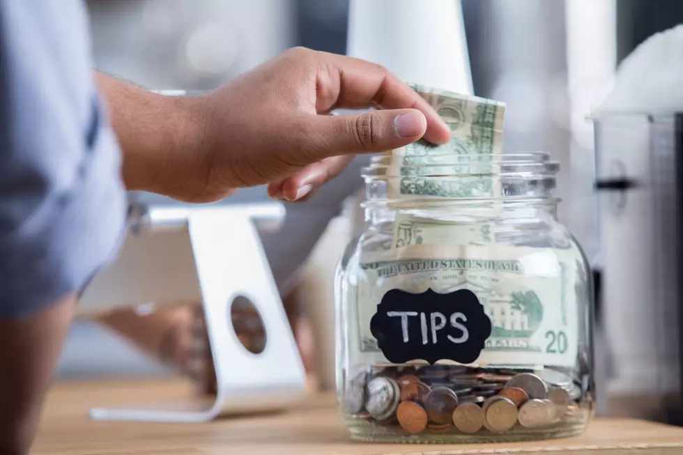 Man putting change into a tip jar