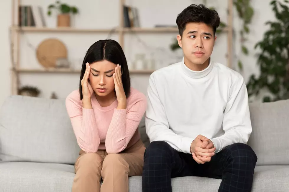 A couple looks embarrassed on the couch