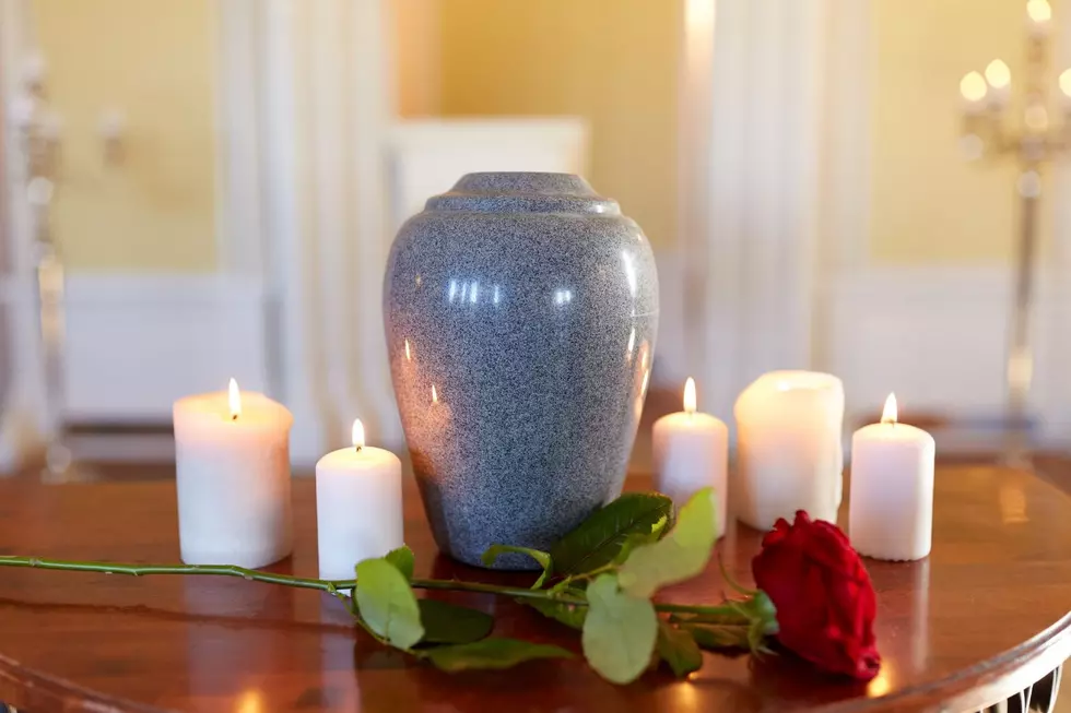 An urn with candles and flowers surrounding it