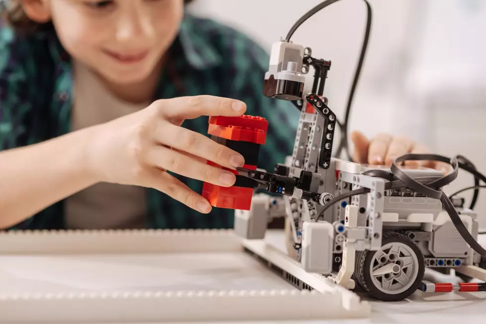Young girl plays with Lego Technic
